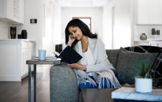 woman reading a book on the couch