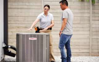 HVAC technician explaining a Lennox HVAC unit to a homeowner