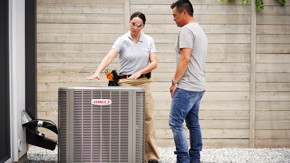 HVAC technician explaining a Lennox HVAC unit to a homeowner