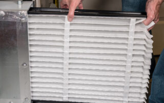 man changing an air filter