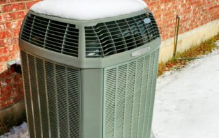 outdoor HVAC unit covered in snow