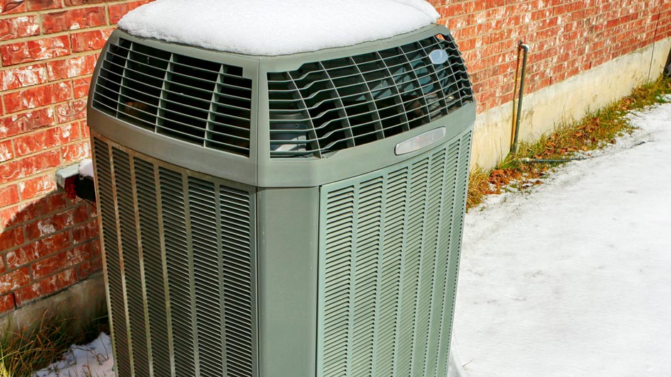 outdoor HVAC unit covered in snow