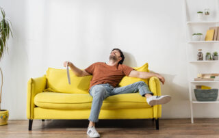 man sweating on his living room couch